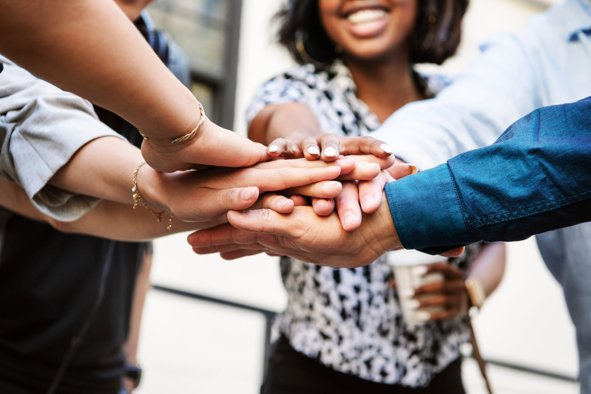 Diverse startup business team stacking hands