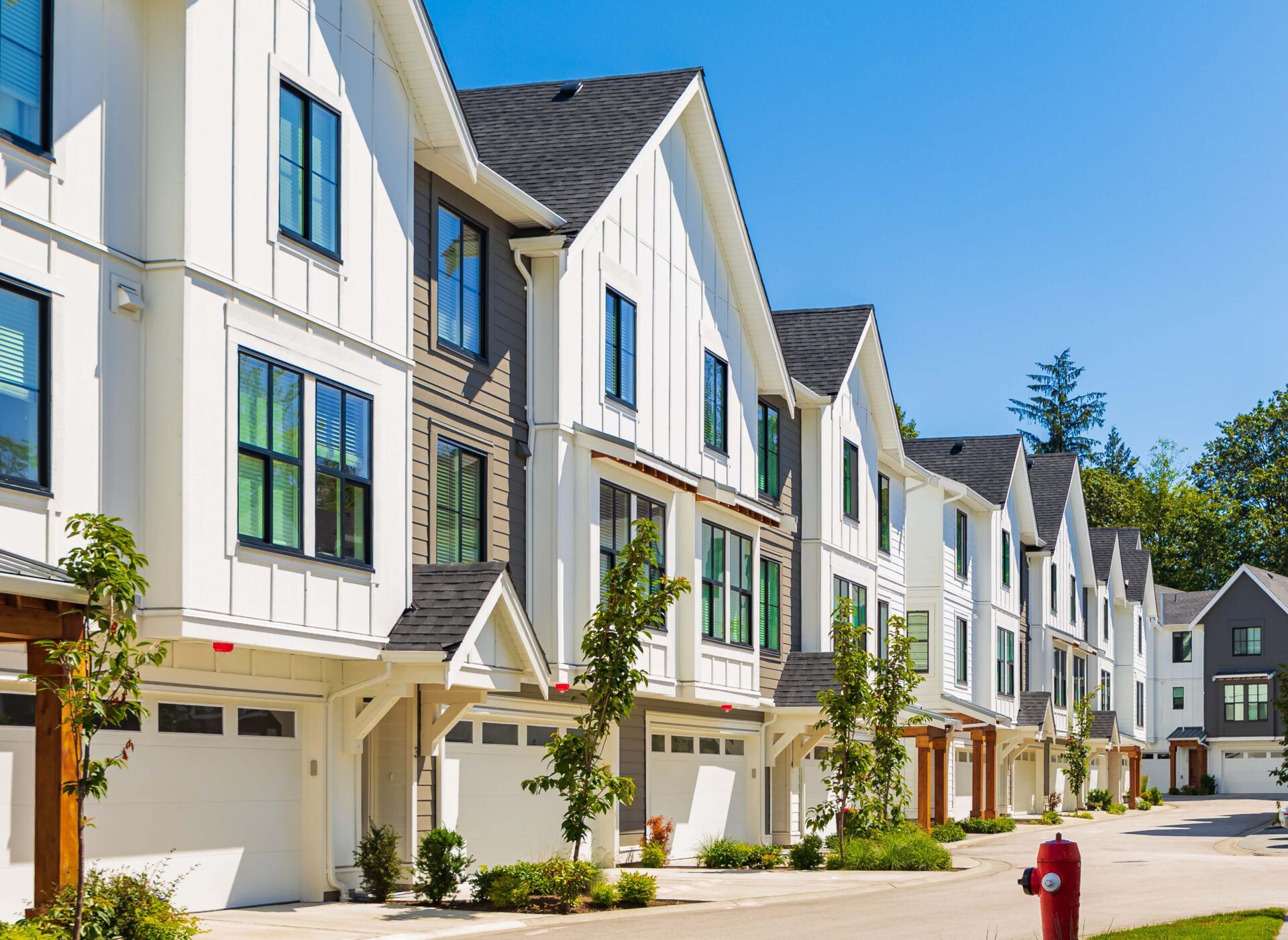 A series of large brown coloured houses with large lawn upfront.RL Property Management can provide property management for houses like this