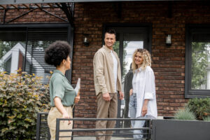 woman showing a rental property to a happy couple