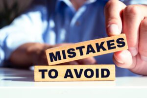 Wooden blocks with text Mistakes To Avoid written on it