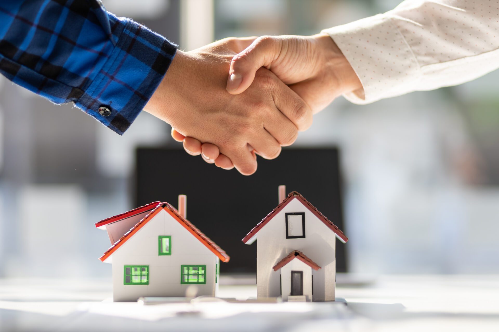 Handshake between a real estate agent and property management company for a referral agreement 