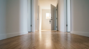 Empty hallway and a vacant rental property with a key hanging out of the door knob.